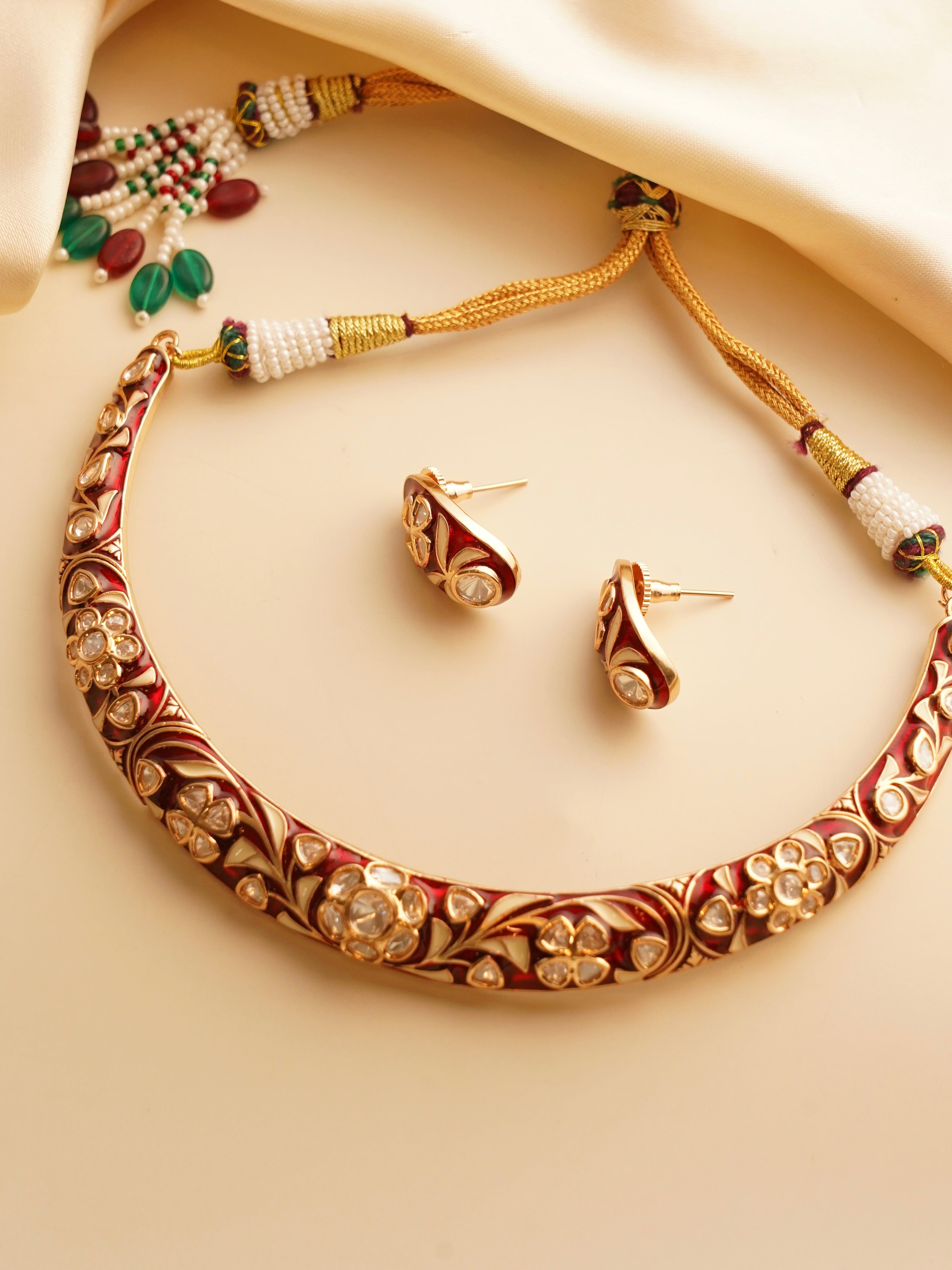 Side view of meenakari hasli with intricate enamel work and curved structure